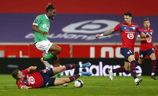 Saint-Etienne player Charles Abi jumps over Sven Botman, Losc player, who tries to tackle him on May 16 in Lille.