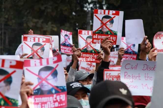 On February 8, 2021, demonstrators hold up placards denouncing the head of the State Administration Council, General Min Aung Hlaing, as they take part in a demonstration against the military coup, in Myitkyina, in the 'Kachin State, Burma.