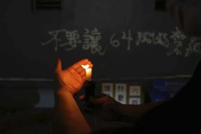 A protester lights a candle in Hong Kong on June 4, 2021.