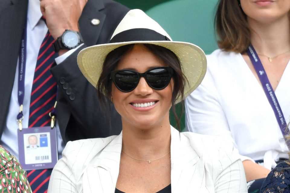 Duchess Meghan with sunglasses and a panama hat. 
