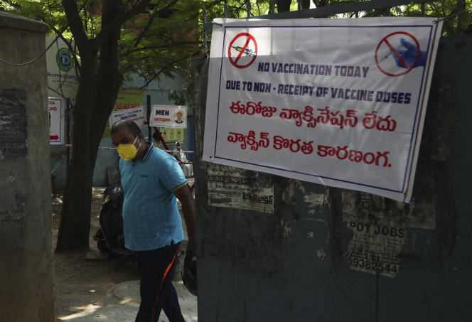 A man walks past a portal with a poster saying no vaccine doses have been received at this vaccination center in Hyderabad, India on May 3, 2021.