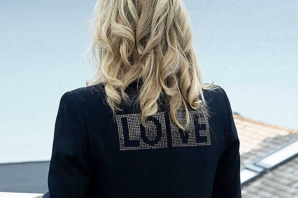Dr.  Jill Biden wears a black Zadig & Voltaire blazer.  The word is emblazoned in rhinestones on the back "Love". 