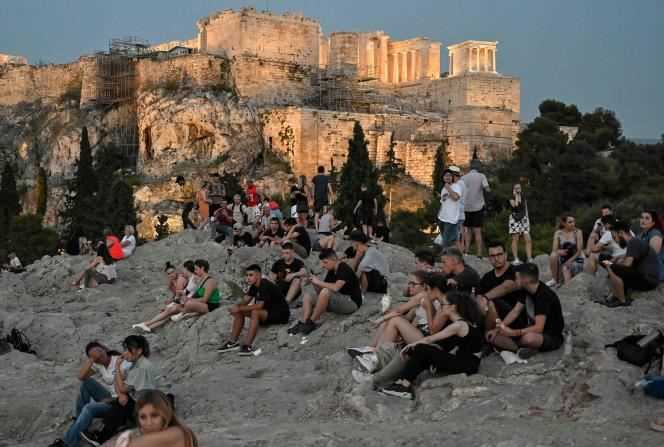 Young Greeks sit on the Aeropagus near the Acropolis in Athens on June 24.