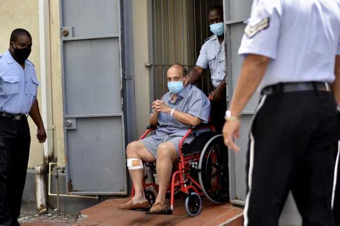 Businessman Mehul Choksi exits in a wheelchair from the Magistrate's Court in Roseau, Dominica on June 4, 2021.