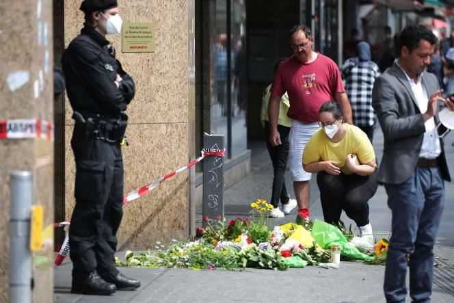 People gather in front of a makeshift memorial to the victims of a deadly attack in downtown Würzburg, southern Germany, June 26, 2021.