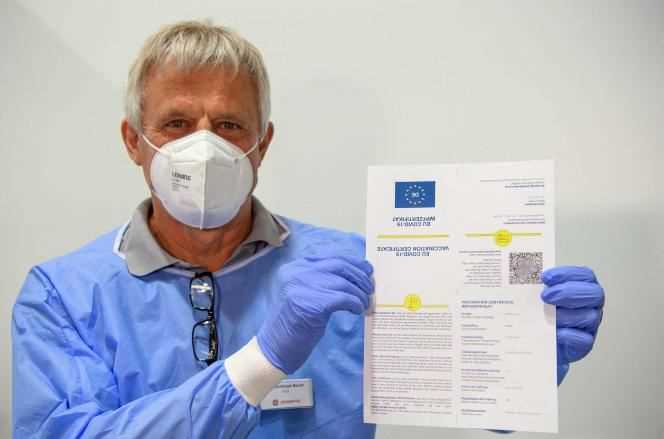 Dr Christoph Borch presents a model vaccination passport (CovPass), at the Babelsberg Vaccination Center, Potsdam, Germany on May 27, 2021.