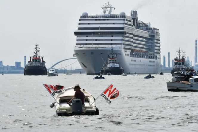 An environmental activist protests aboard a small boat against the presence of cruise ships in the lagoon, in Venice (Italy), June 5, 2021.