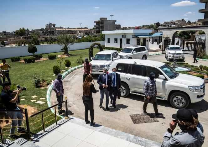 Members of the Kurdish security forces stand guard as a Dutch diplomatic delegation arrives, led by the Dutch special envoy to Syria Emiel de Bont (left) and the director of consular affairs at the ministry Dutch Foreign Affairs Officer Dirk Jan Nieuwenhuis (right), who was handed over to relatives of ISIS fighters in the northeastern Syrian town of Qamishli on June 5, 2021.