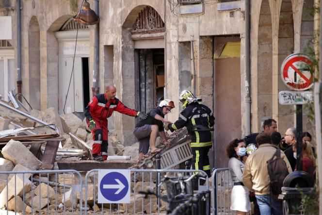 A resident is evacuated by firefighters from a building that collapsed in Bordeaux on June 21, 2021.