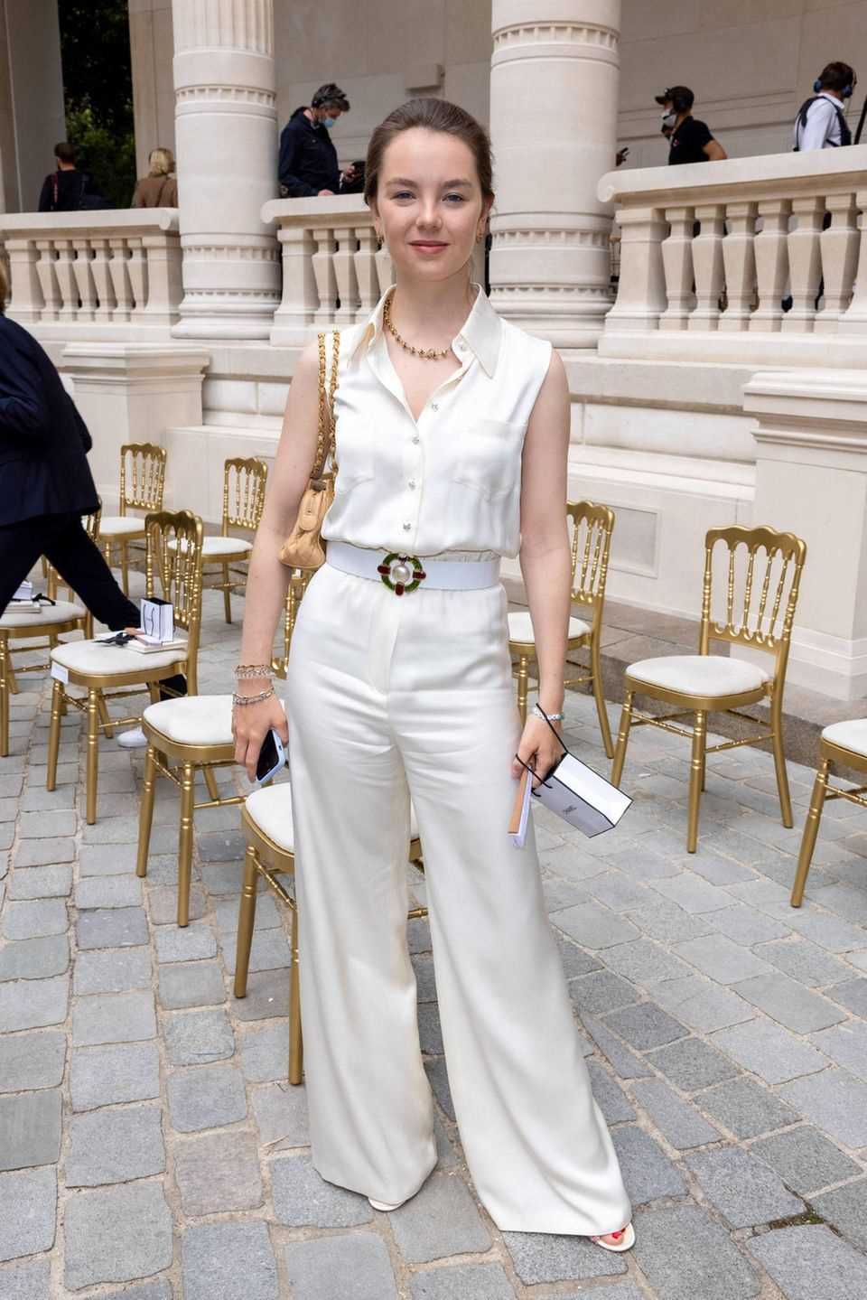 Alexandra von Hannover at the Chanel Haute Couture Show in Paris.  She puts on a pair of wide pants made of light-colored satin. 
