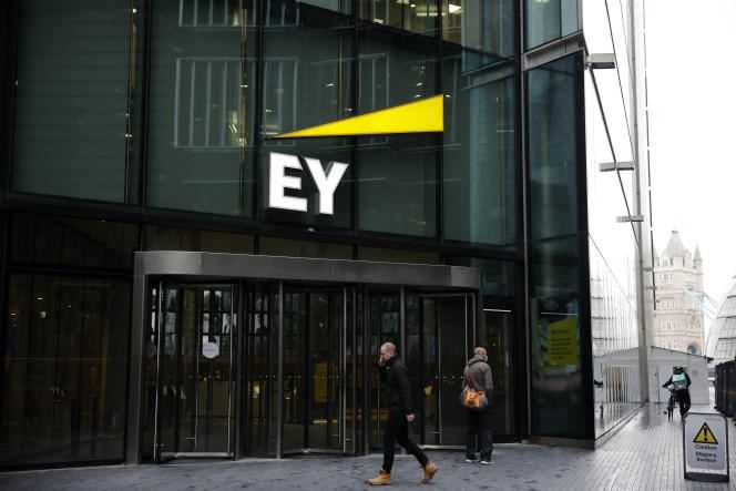 Pedestrians walk past the offices of accounting and auditing firm EY, formerly Ernst & Young, in London, November 20, 2020.