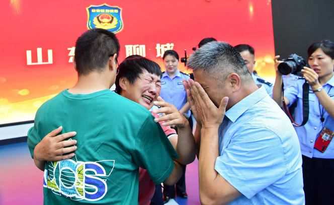 The reunion of 26-year-old Guo Xinzhen (from behind) and his parents on July 11, 2021, in Liocheng, China.