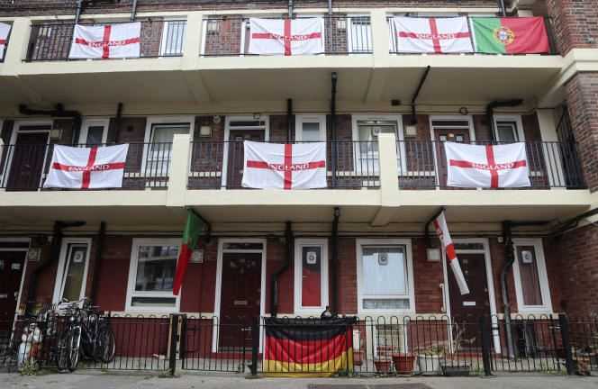 A German flag, bottom center, is among the English and Portuguese flags that adorn the balconies and landings of the Kirby housing estate in London on Tuesday, June 29, 2021.