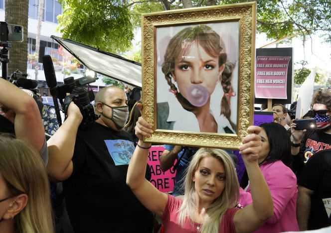 A Britney Spears fan holds a portrait of the singer outside the Stanley Mosk court in Los Angeles on July 14, 2021.
