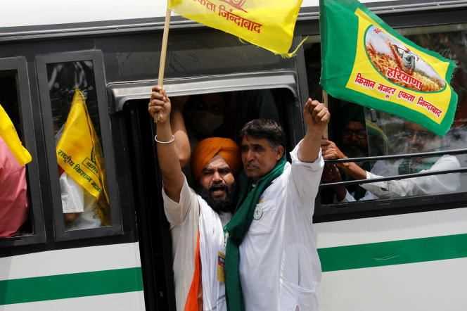 Farmers shout slogans as they arrive on a bus to attend a sit-in protest against farm laws near parliament in New Delhi, India on July 22, 2021.