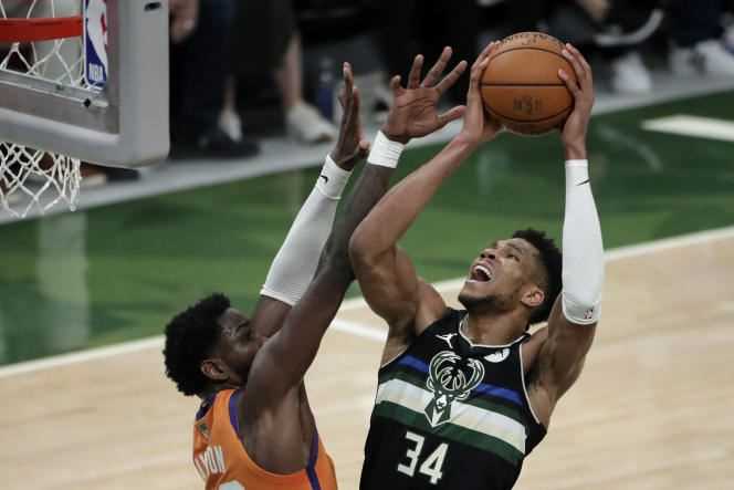 Milwaukee Bucks winger Giannis Antetokounmpo battles Phoenix Suns Deandre Ayton in the NBA Finals on July 20, 2021, in Milwaukee.