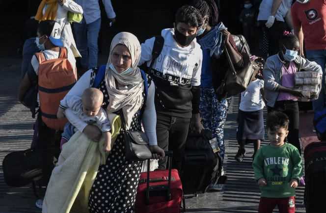 Refugees from the islands of Lesbos, Chios, Samos, Kos and Leros arrive at the port of Lavrio on September 29, 2020.