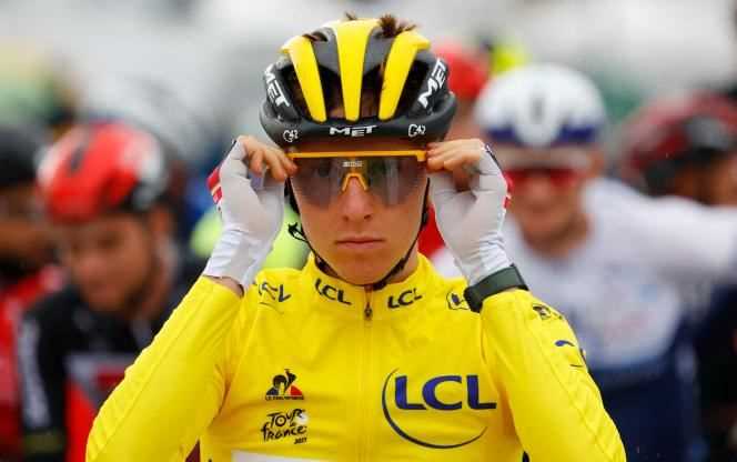 Slovenian Tadej Pogacar, wearing the leader's yellow jersey, adjusts his glasses before the start of the ninth stage of the 108th edition of the Tour de France between Cluses and Tignes on July 4, 2021.