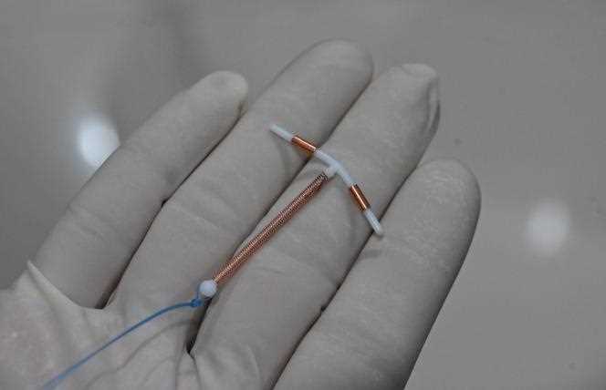 On June 25, 2020, a doctor holds an IUD to be placed in a patient's uterus at a clinic in Jakarta, Indonesia.