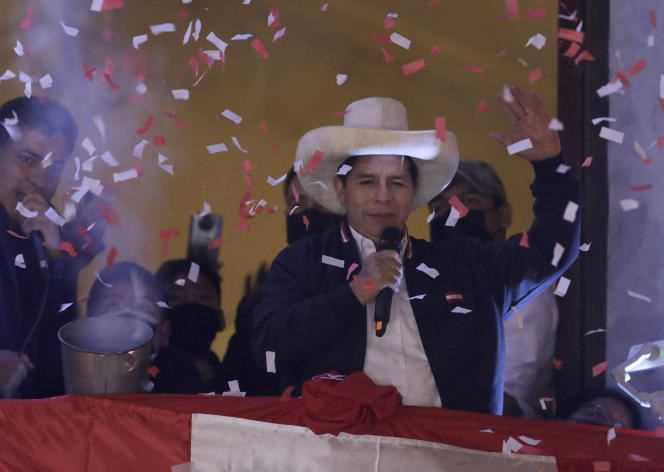 Pedro Castillo greets his supporters after election officials declared him elected president during celebrations at his party's campaign headquarters in Lima, Peru on July 19, 2021.