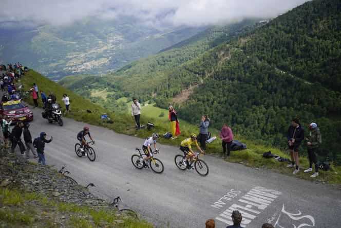 The Slovenian Tadej Pogacar, winner of the stage, wearing the yellow jersey, the Danish Jonas Vingegaard, second, wearing the white jersey of the best youngster, and the Ecuadorian Richard Carapaz, third, climb the Col du Portet during the ten- seventh stage of the Tour de France, Wednesday July 14, 2021.
