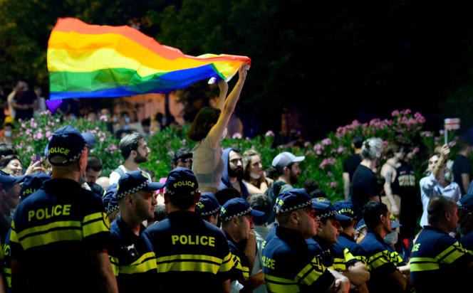 A protester waves a rainbow flag during a protest in support of those injured in violence on the sidelines of a Pride March in Tbilisi, Georgia on July 6, 2021.