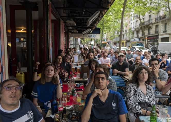 Supporters watch the Euro football match between France and Hungary, on the terrace of a Parisian café, on June 19, 2021.