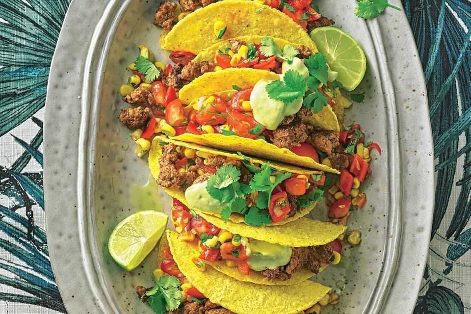 Tacos with tomato and corn salad and avocado dip