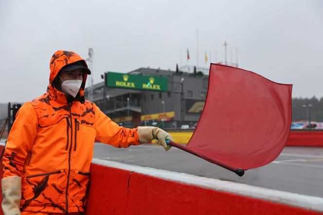 A Formula 1 Belgian Grand Prix commissioner waves the red flag on the Spa-Francorchamps circuit, Sunday, August 29.
