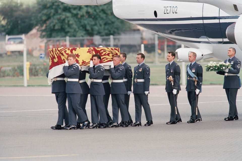 Princess Diana's coffin arrives in England.  He's with that "Royal Standard", the flag of Queen Elizabeth. 
