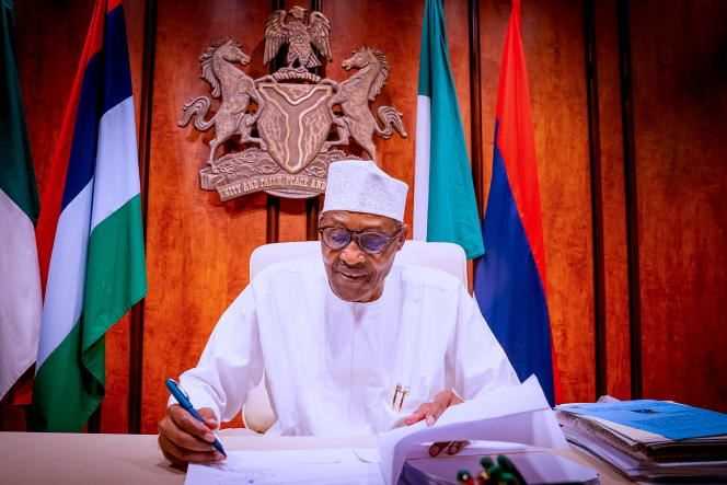 President Muhammadu Buhari signs the Petroleum Industry Bill in Abuja on August 16, 2021.