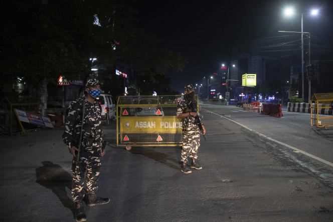 Indian paramilitaries patrol during a curfew in Gauhati, Assam, India on Sunday, May 9, 2021.