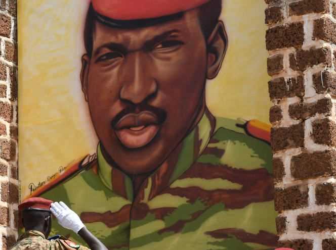 A Burkinabe soldier salutes a giant portrait of Thomas Sankara, in Ouagadougou, October 15, 2019.