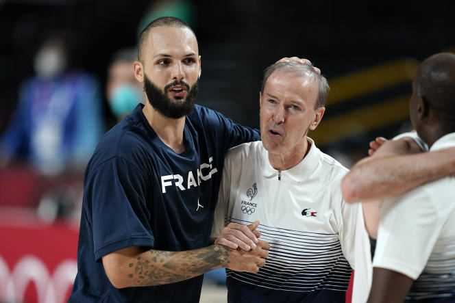 Frenchman Evan Fournier and coach Vincent Collet celebrate the French basketball team's semi-final victory over Slovenia at the Tokyo Olympics on August 5, 2021, in Saitama, Japan.