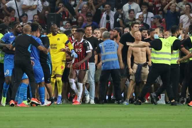 Supporters try to enter the pitch during the football match between OGC Nice and Olympique de Marseille, in Nice, on August 22, 2021.