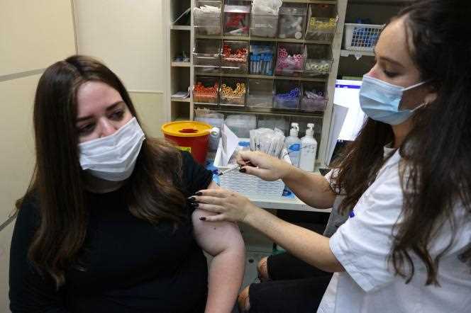 An Israeli woman is injected with a third dose of Pfizer-BioNtech's Covid-19 vaccine in Jerusalem on August 20, 2021.