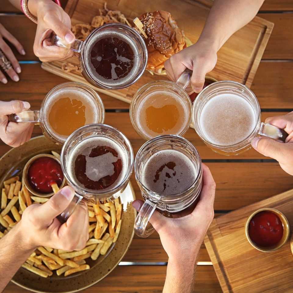 Inflammatory foods: burgers, fries, and alcohol on the table