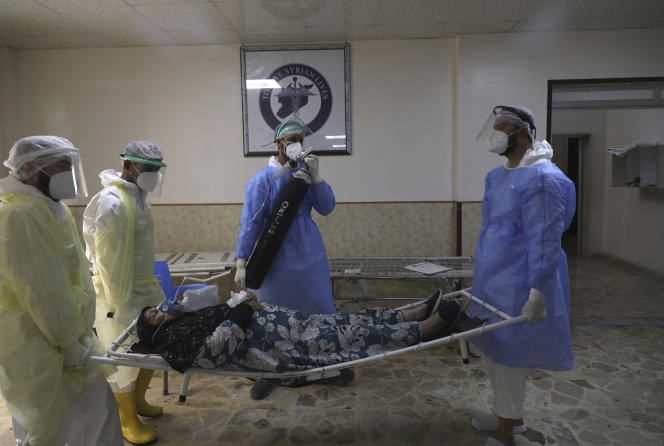 Medics transport a patient with Covid-19 to the Syrian-American Medical Society hospital in Idlib, northwestern Syria, on September 20, 2021.