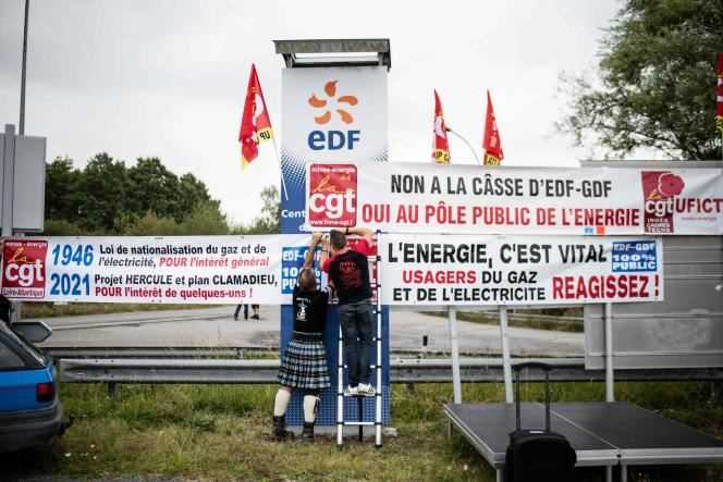EDF employees attach a banner in front of the Cordemais coal-fired power plant in western France on September 16, 2021.