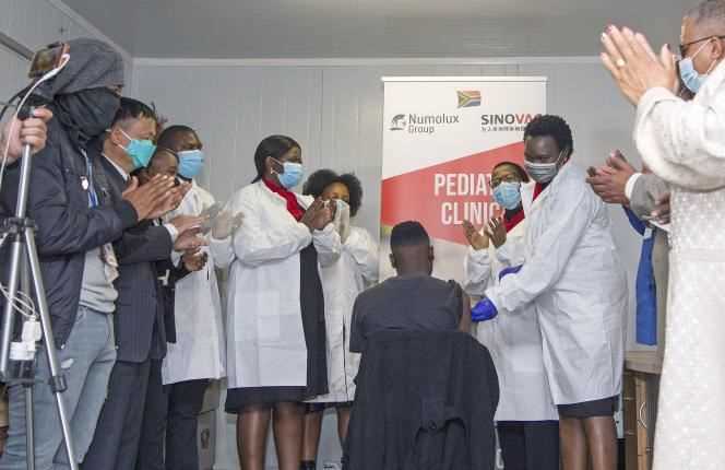 People applaud after a dose of Sinovac's CoronaVac vaccine is administered to a teenager in Pretoria, South Africa on September 10, 2021.