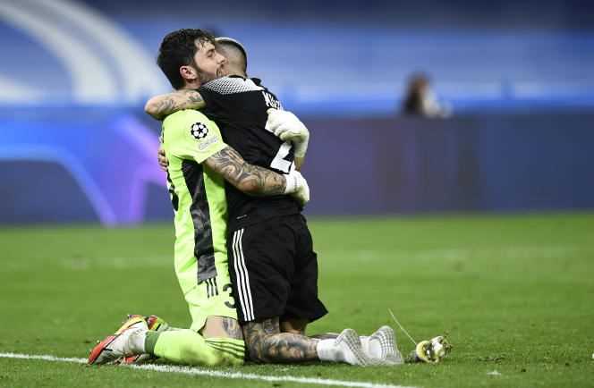 Sheriff Tiraspol goalkeeper Giorgos Athanasiadis celebrates his club's victory over Real Madrid in the arms of Dimitris Kolovos at the Bernabeu stadium in Madrid on September 28, 2021.