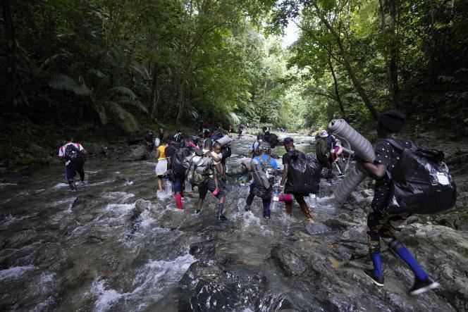 Migrants cross the Acandi River in Colombia to get closer to the Darien jungle on September 15, 2021.