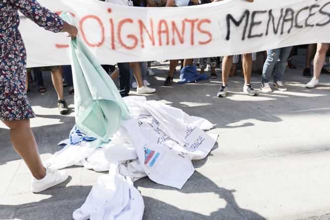 The caregivers of the Ajaccian collective Soignants Menacs symbolically deposit their gowns in front of the Prefecture of Corse-du-Sud on the Cours Napoléon in Ajaccio, in order to demonstrate their opposition to compulsory vaccination on September 11, 2021.