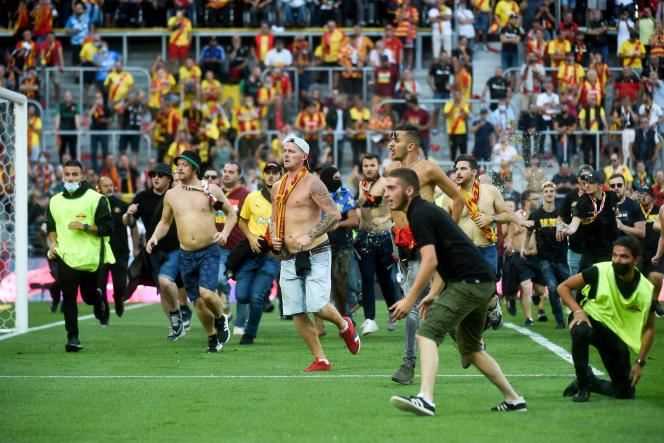 Lens supporters invaded the field to meet Lille during the Lens-Lille derby on September 18.