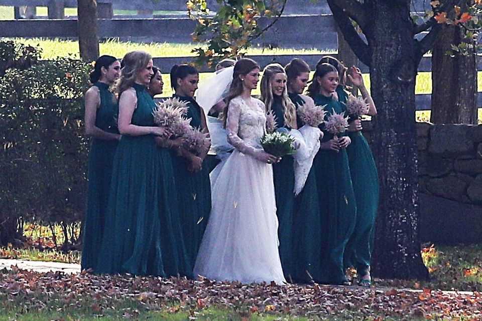 Jennifer Gates poses for the wedding photographer with her bridesmaids. 