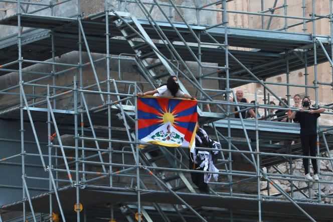 A protester holds a Tibetan flag during a demonstration at the Propylaea Acropolis in Athens, Greece, October 17, 2021.