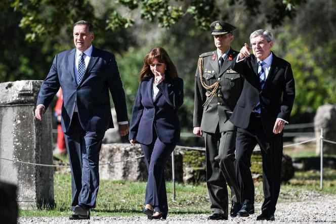 From left to right: President of the Hellenic Olympic Committee and IOC member Spyros Capralos, President of Greece Ekateríni Sakellaropoulou and IOC President Thomas Bach arrive for the Olympic flame lighting ceremony on 18 October 2021.