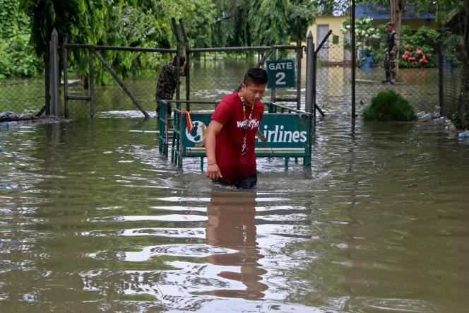 An airline employee in the flooded Biratnagar airport in Nepal on October 20, 2021.