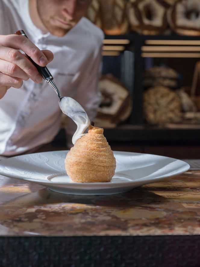 Chef Maxime Frédéric puts the finishing touches on his puffed pear.
