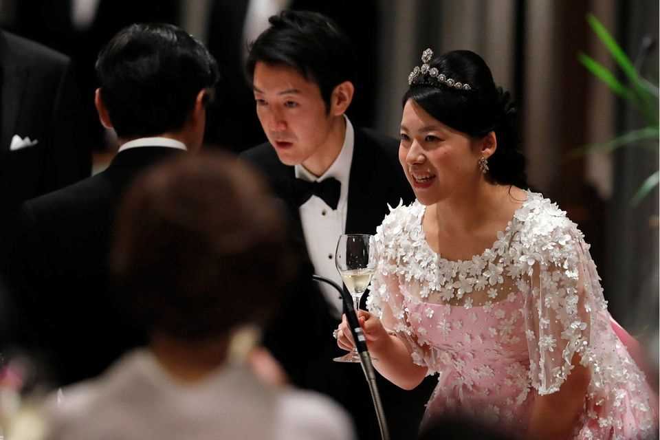 Princess Ayako and her husband Kei Moriya toast with Crown Prince Naruhito at their wedding banquet in Tokyo on October 30, 2018. 